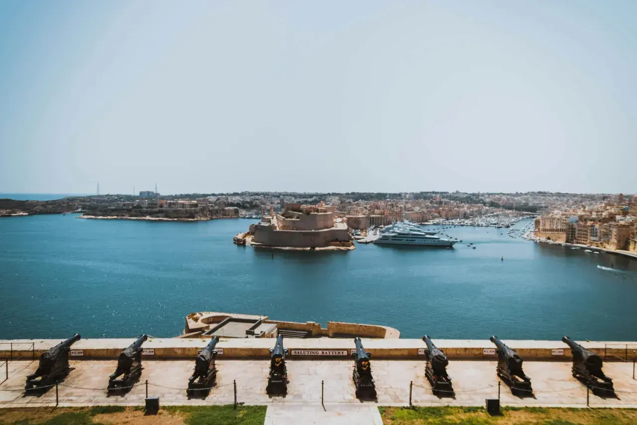 Malta wyspa, do której należy ta malownicza panorama z armatami, fortecą i luksusowymi jachtami, to perła Morza Śródziemnego.